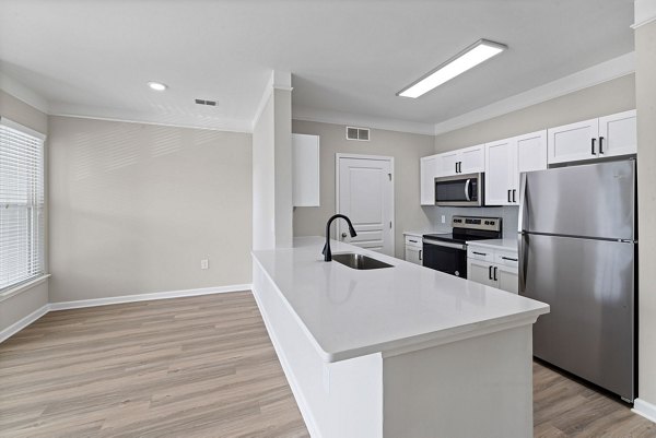 Modern kitchen with stainless steel appliances at Windsor at Tryon Village Apartments