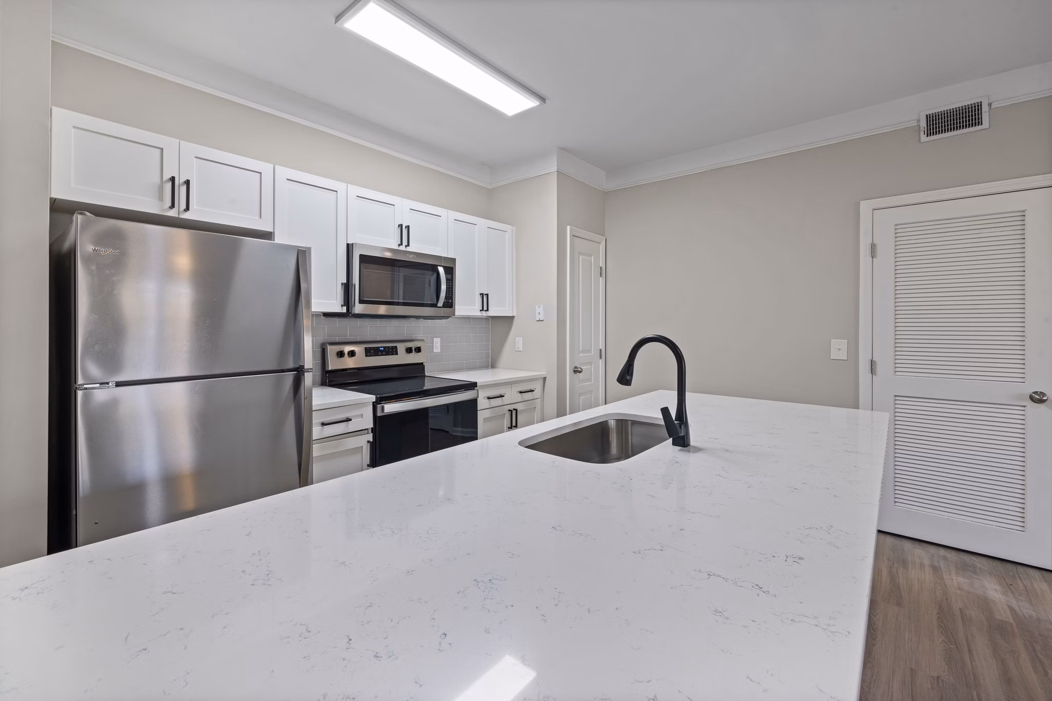 Windsor at Tryon Village: Modern kitchen with stainless steel appliances and quartz countertops in Cary apartments