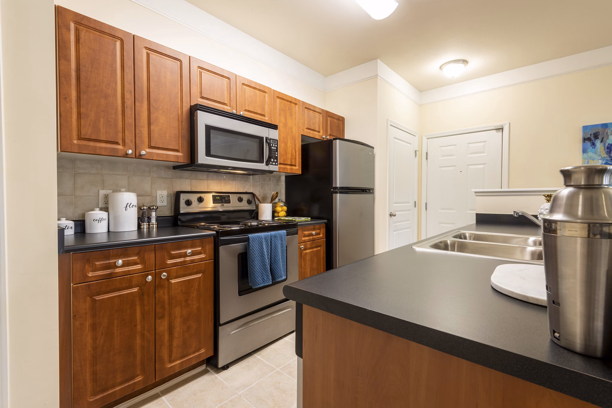 Modern kitchen with stainless steel appliances at Windsor at Tryon Village Apartments