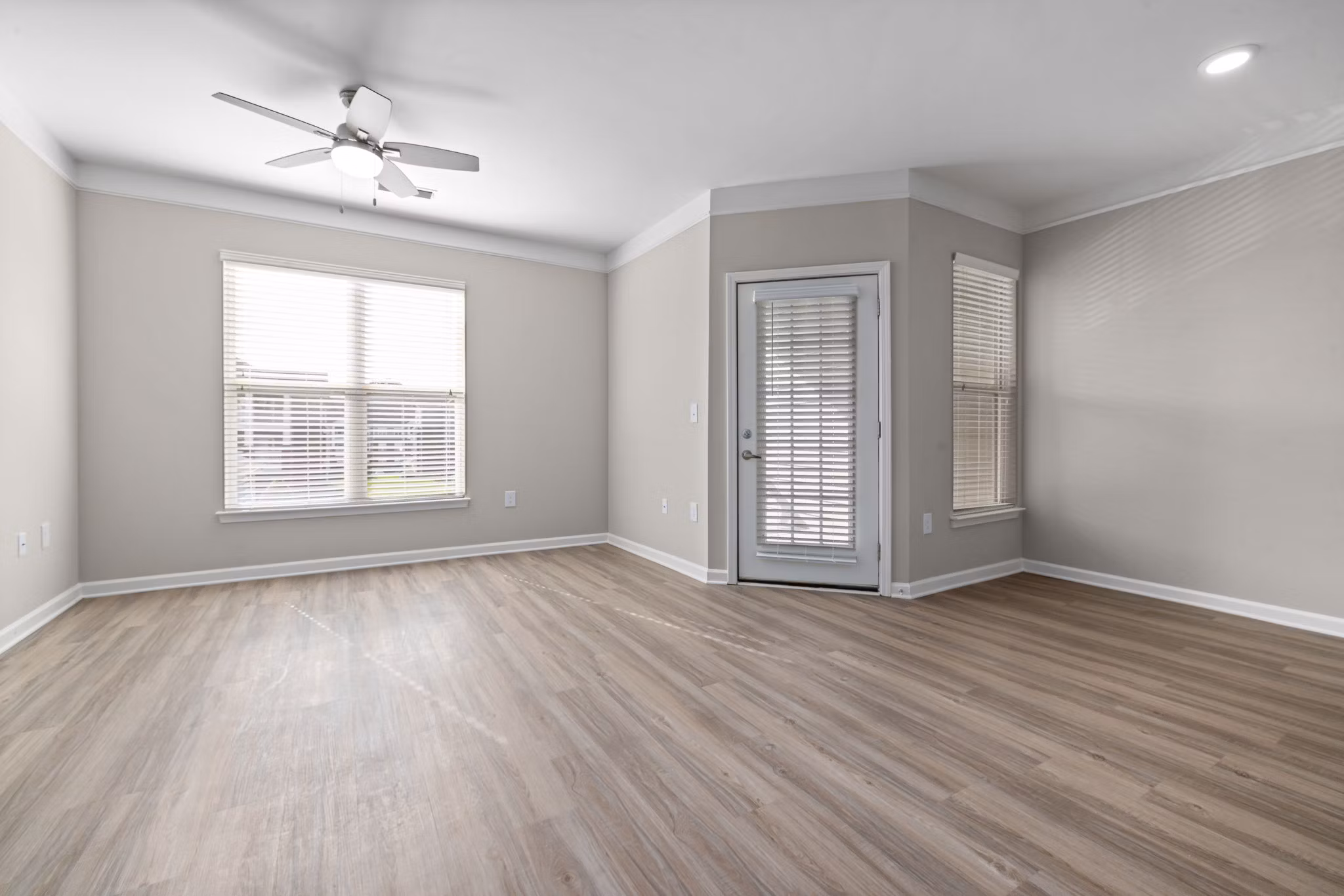 Modern living room with stylish furnishings and large windows at Windsor at Tryon Village Apartments