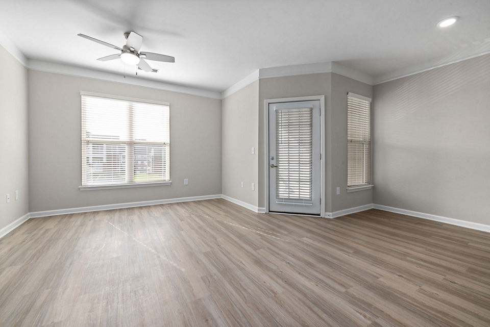 Modern living room with stylish furnishings and large windows at Windsor at Tryon Village Apartments