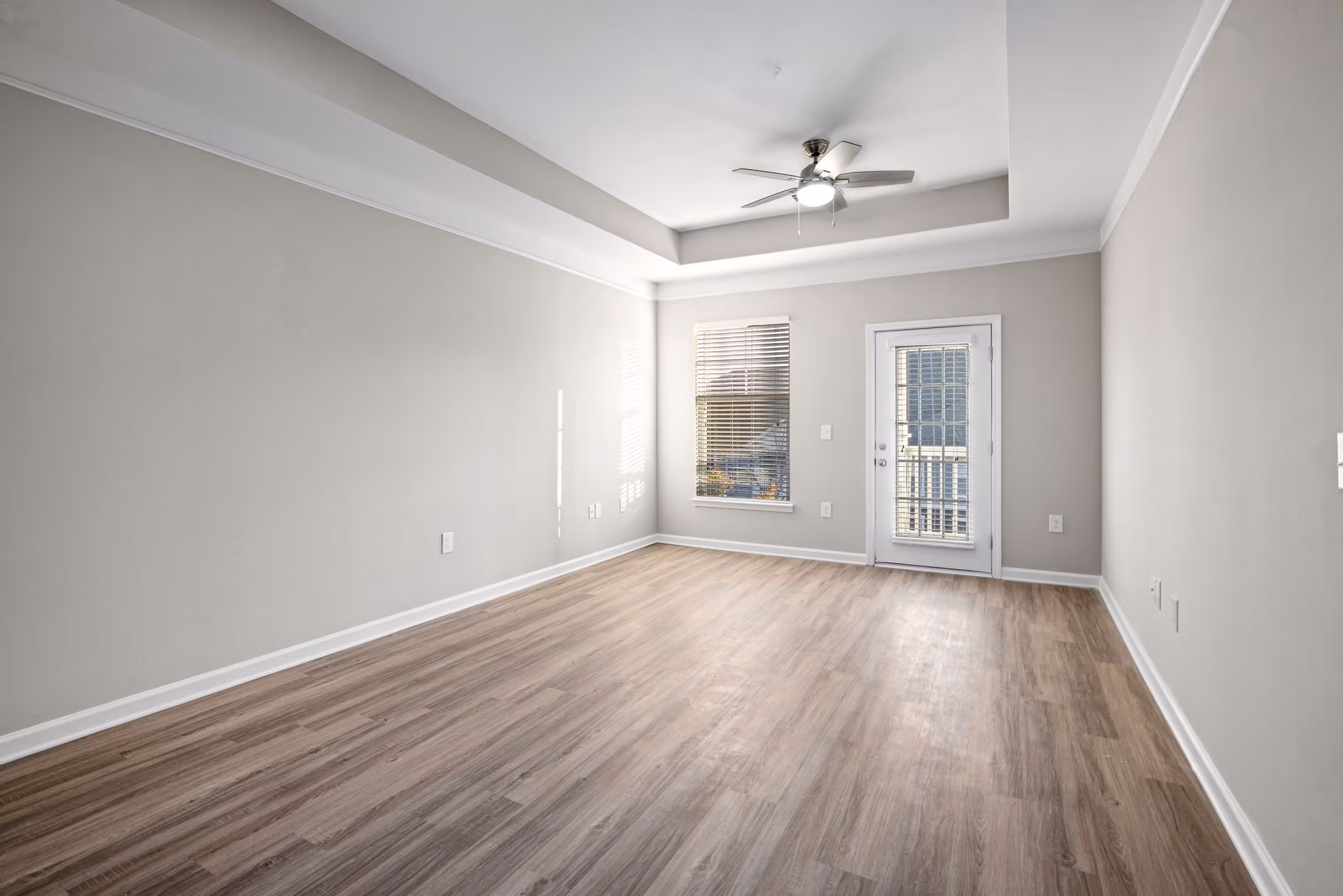 Spacious living room with modern dÃ©cor and large windows at Windsor at Tryon Village Apartments, offering luxury living