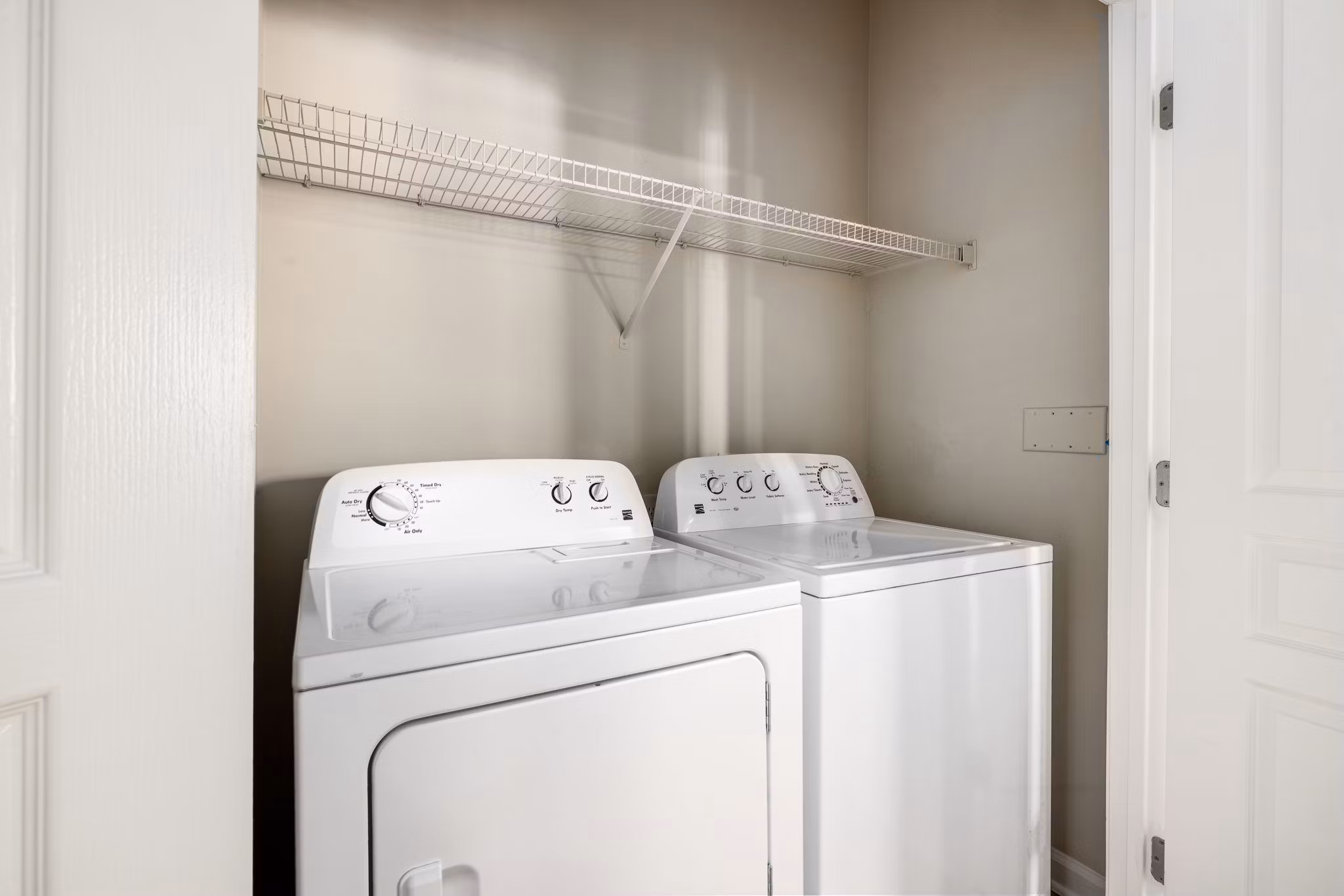 Laundry room with modern appliances at Windsor at Tryon Village Apartments in Cary, showcasing convenient living spaces