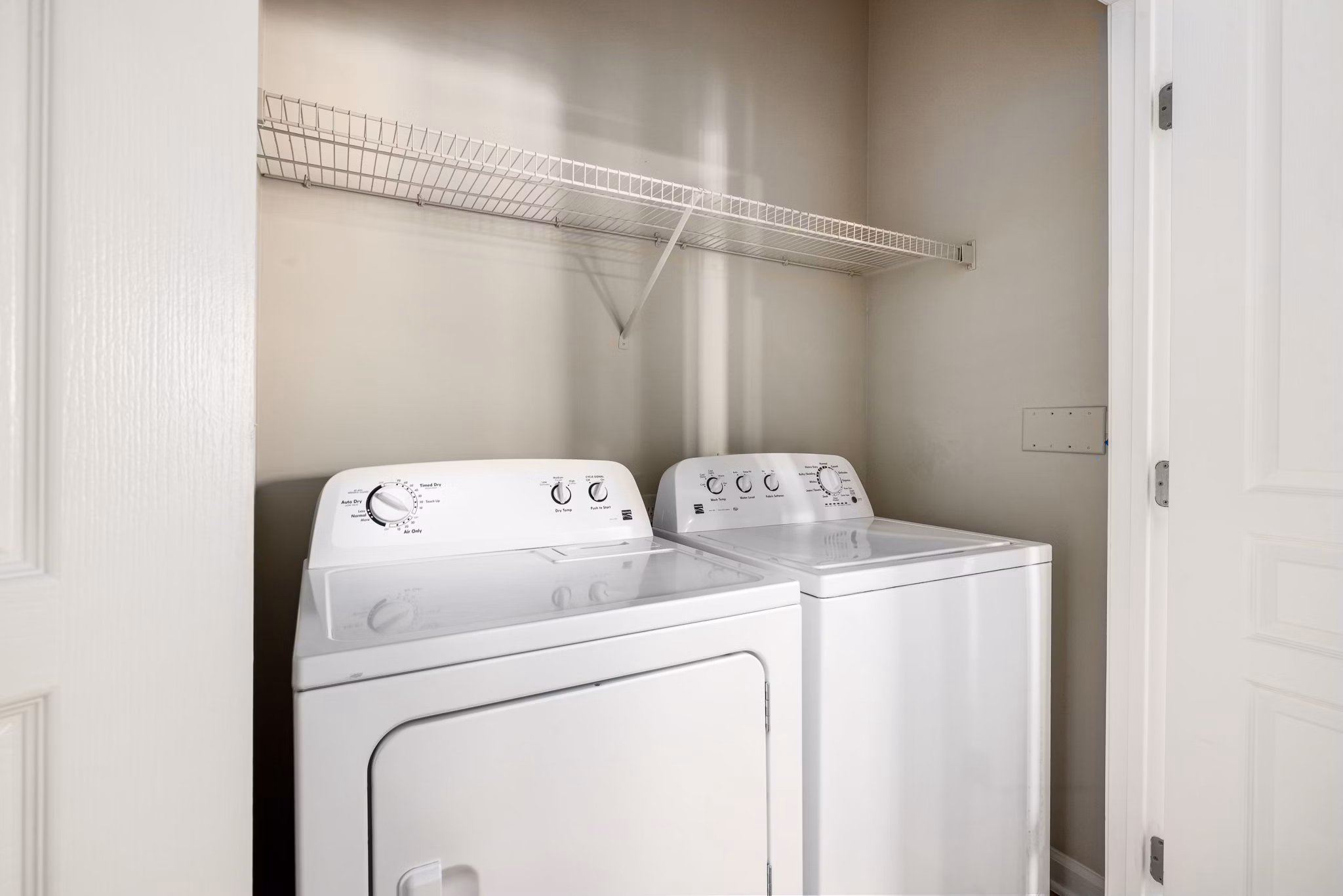 Laundry room with modern appliances at Windsor at Tryon Village Apartments in Cary, showcasing convenient living spaces