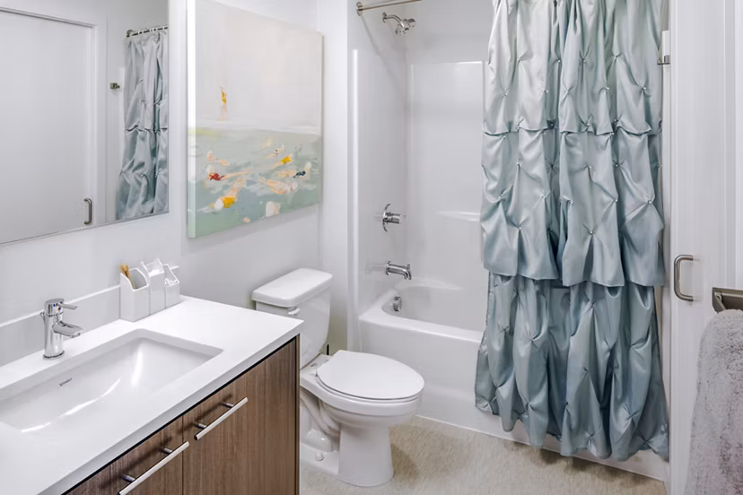 Modern bathroom with sleek fixtures at Dianne Apartments, featuring spacious countertops and bright lighting, ideal for luxury apartment living