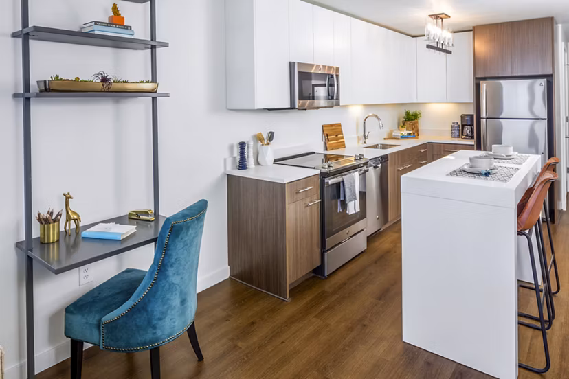 Modern kitchen with sleek cabinetry and integrated home office at Dianne Apartments Features luxury finishes perfect for urban living