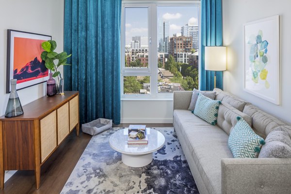 Contemporary living room with modern furnishings at Dianne Apartments, featuring comfortable seating and stylish decor