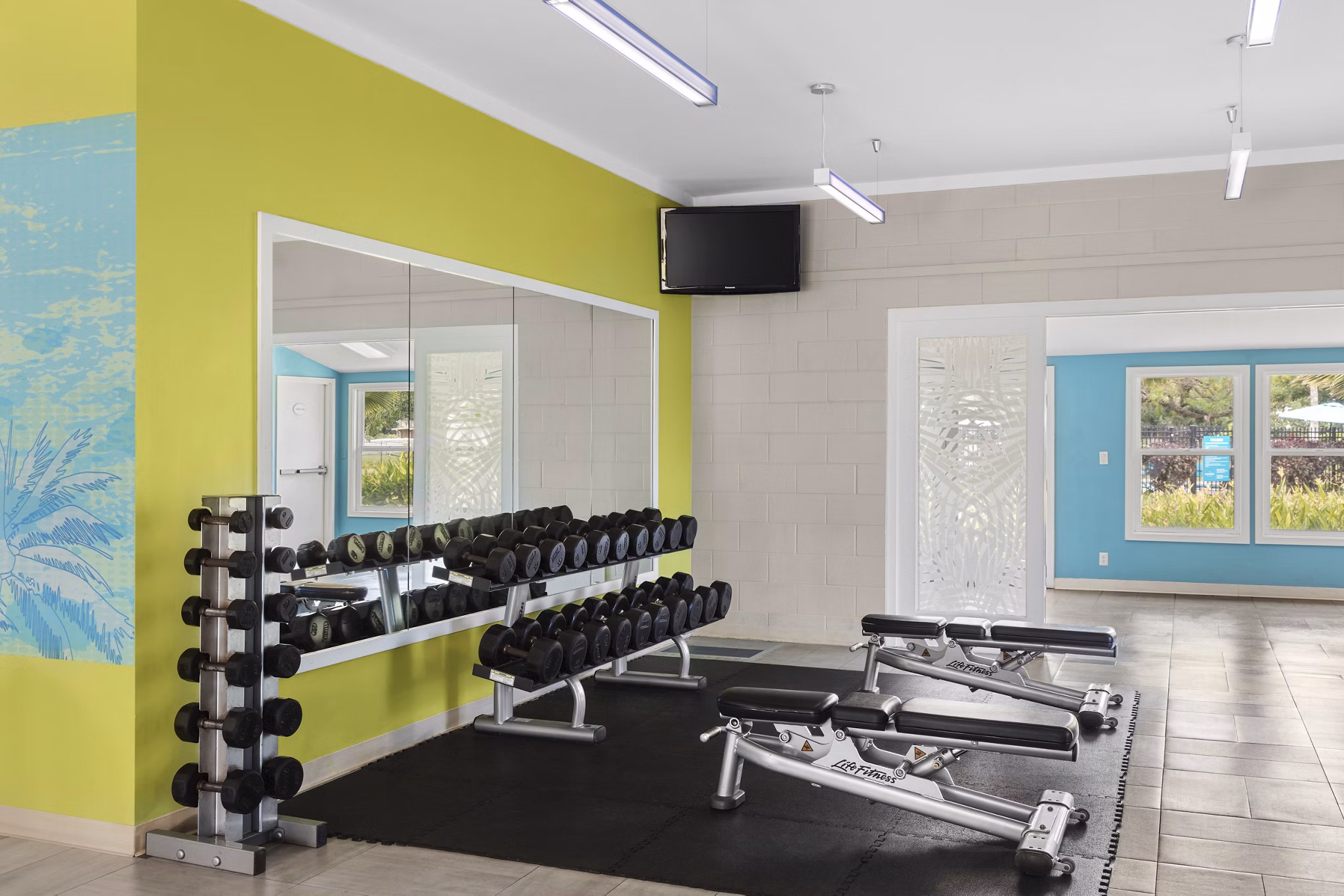 State-of-the-art fitness center with modern equipment at Kalaeloa Rental Homes, perfect for an active lifestyle