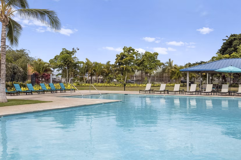 Luxurious swimming pool at Kalaeloa Rental Homes offering serene relaxation ambiance, a perfect escape in sunny Hawaii