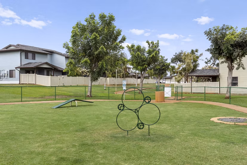 Dog-friendly dog park at Kalaeloa Rental Homes featuring agility equipment and open play areas