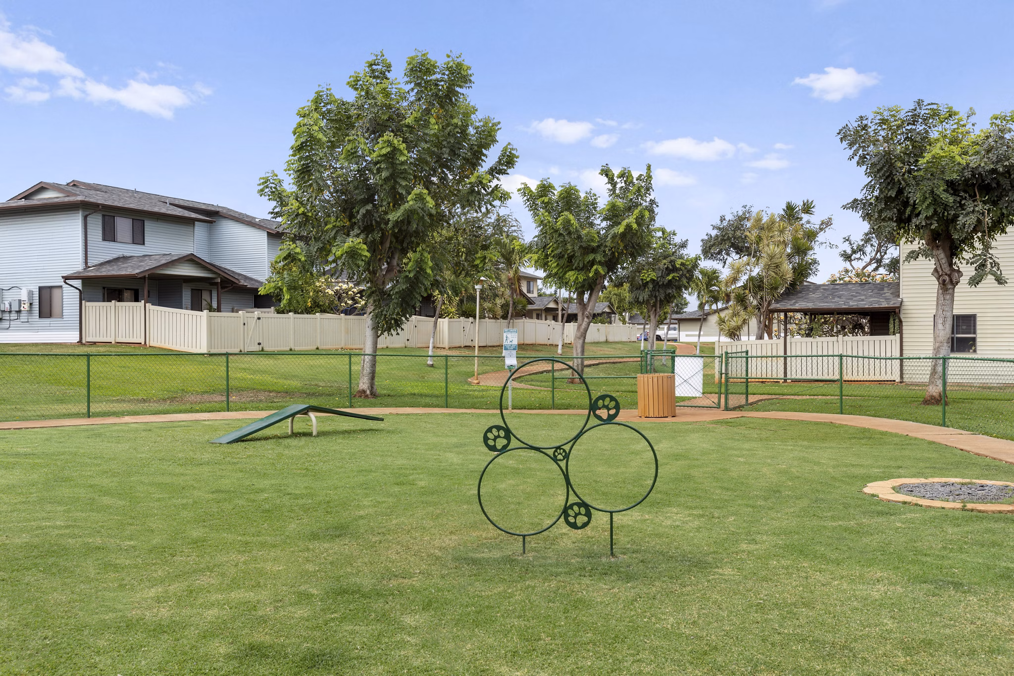 Dog-friendly dog park at Kalaeloa Rental Homes featuring agility equipment and open play areas