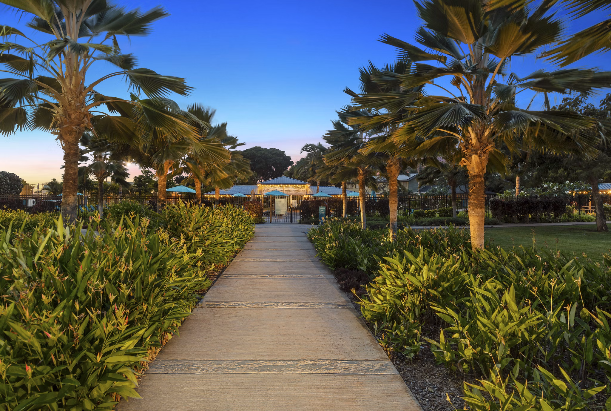 Courtyard at Kalaeloa Rental Homes: Lush outdoor space with seating and gardens in a serene setting