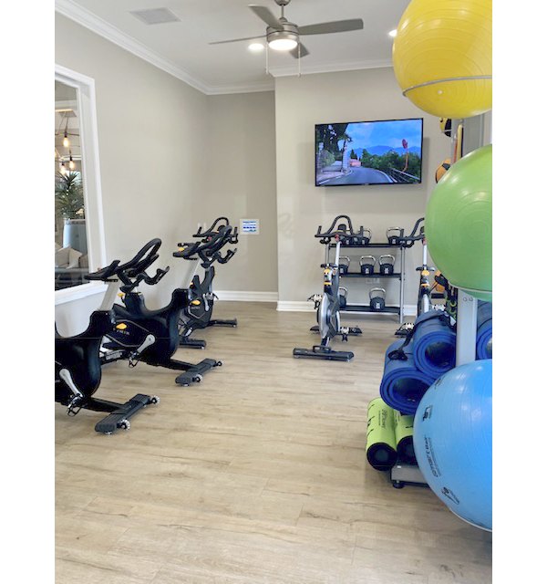 State-of-the-art fitness center with modern equipment at Cape May at Harveston Apartments