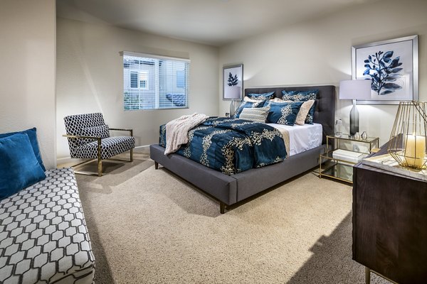 Bedroom with modern furnishings and natural light at Townhomes at Lost Canyon Apartments
