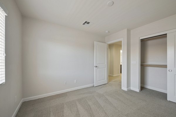 Cozy bedroom with large windows at Townhomes at Lost Canyon Apartments, offering luxury living spaces with modern design