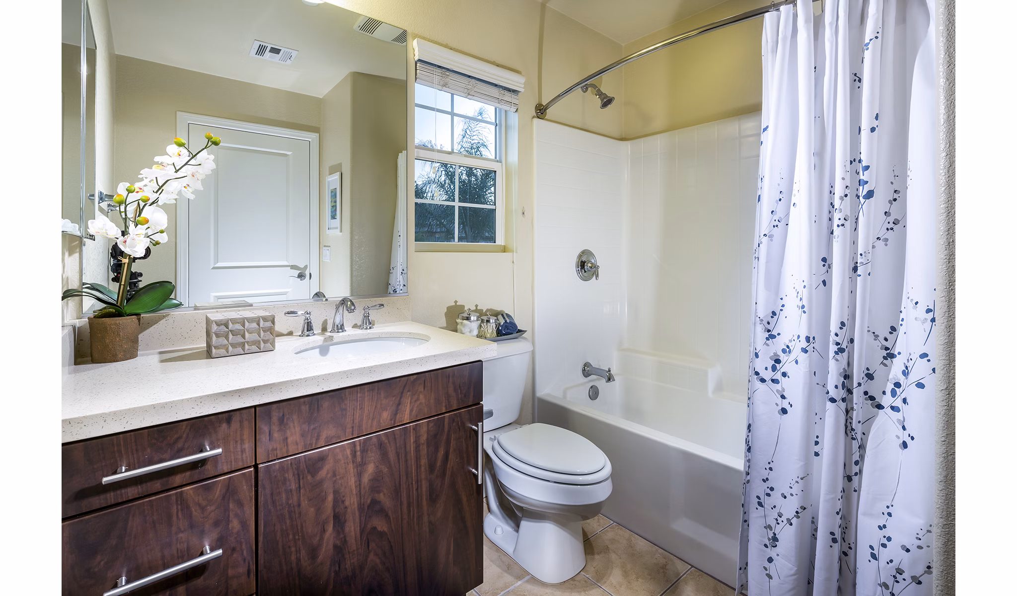 Bathroom with modern vanity and large mirrors in Townhomes at Lost Canyon Apartments