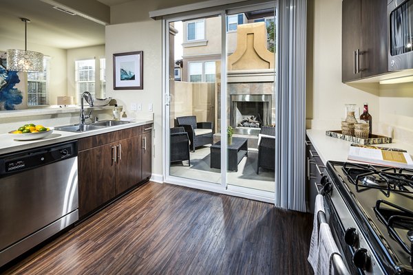 Modern kitchen with stainless steel appliances at Townhomes at Lost Canyon Apartments