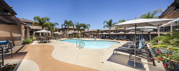 Resort-style pool with lush landscaping at Townhomes at Lost Canyon Apartments