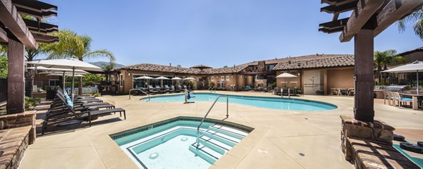 Outdoor swimming pool at Townhomes at Lost Canyon Apartments with lush landscaping, ideal for recreation and relaxation