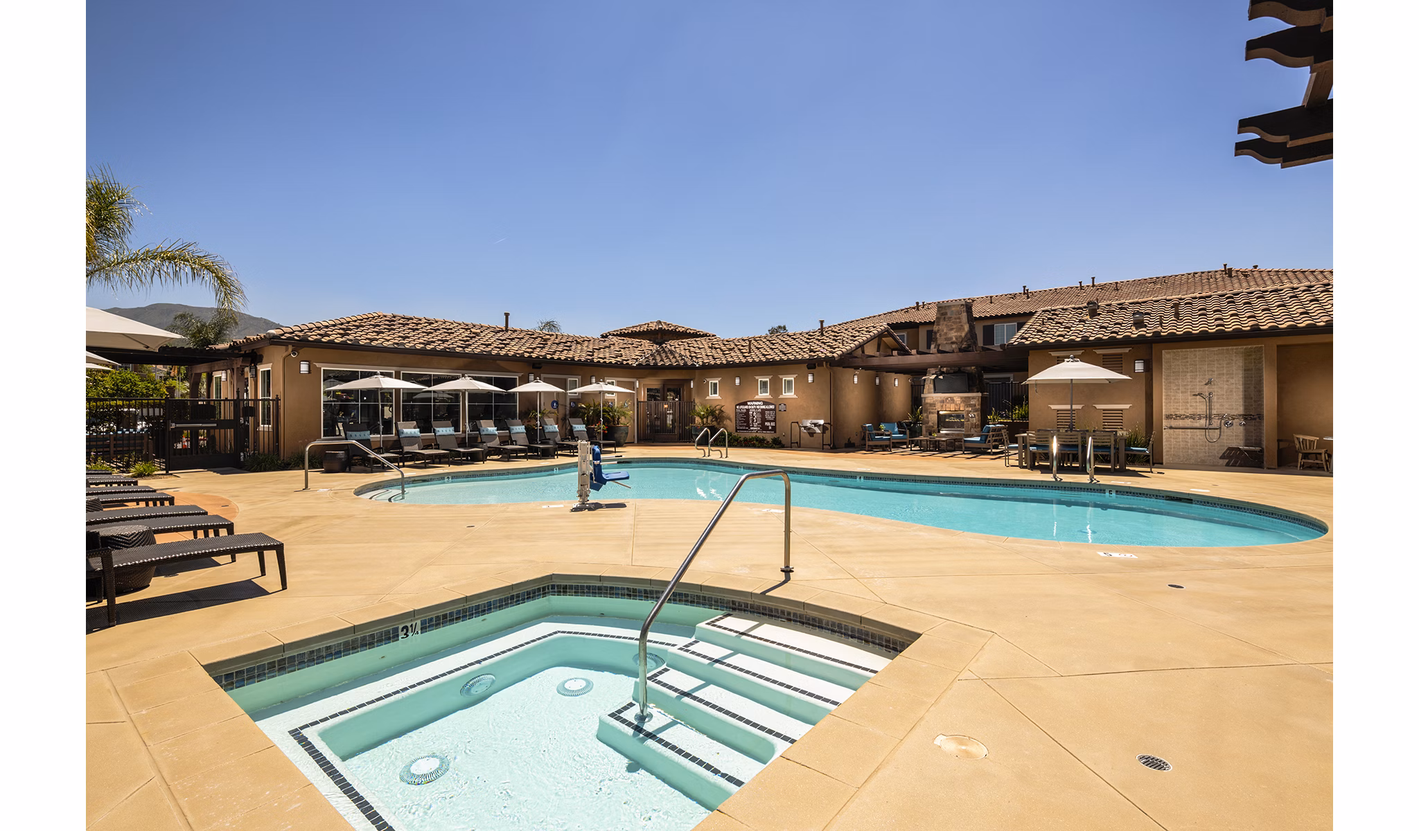 Resort-style pool with lounge chairs at Townhomes at Lost Canyon Apartments, offering a luxurious community feature for residents