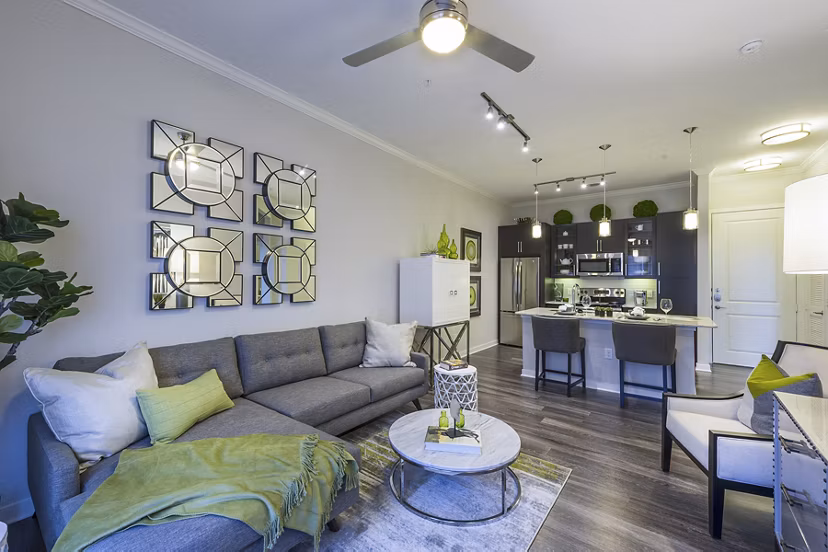 Spacious living room with modern decor and large windows in Overture Sugar Land apartments