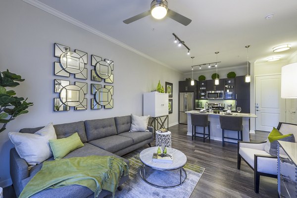 Spacious living room with modern decor and large windows in Overture Sugar Land apartments