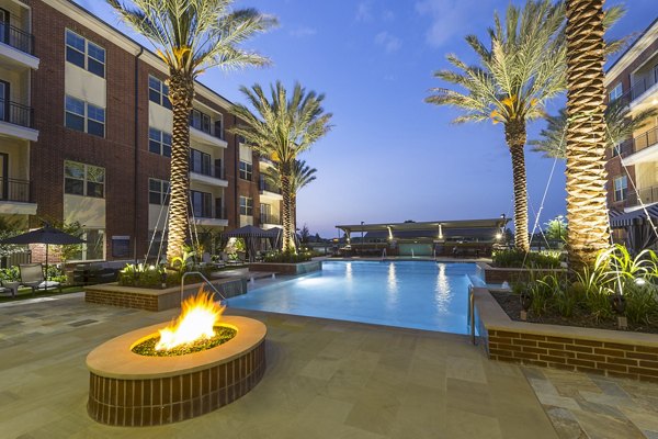 Inviting pool with lounge chairs at Overture Sugar Land, luxury apartments offering a relaxing outdoor amenity