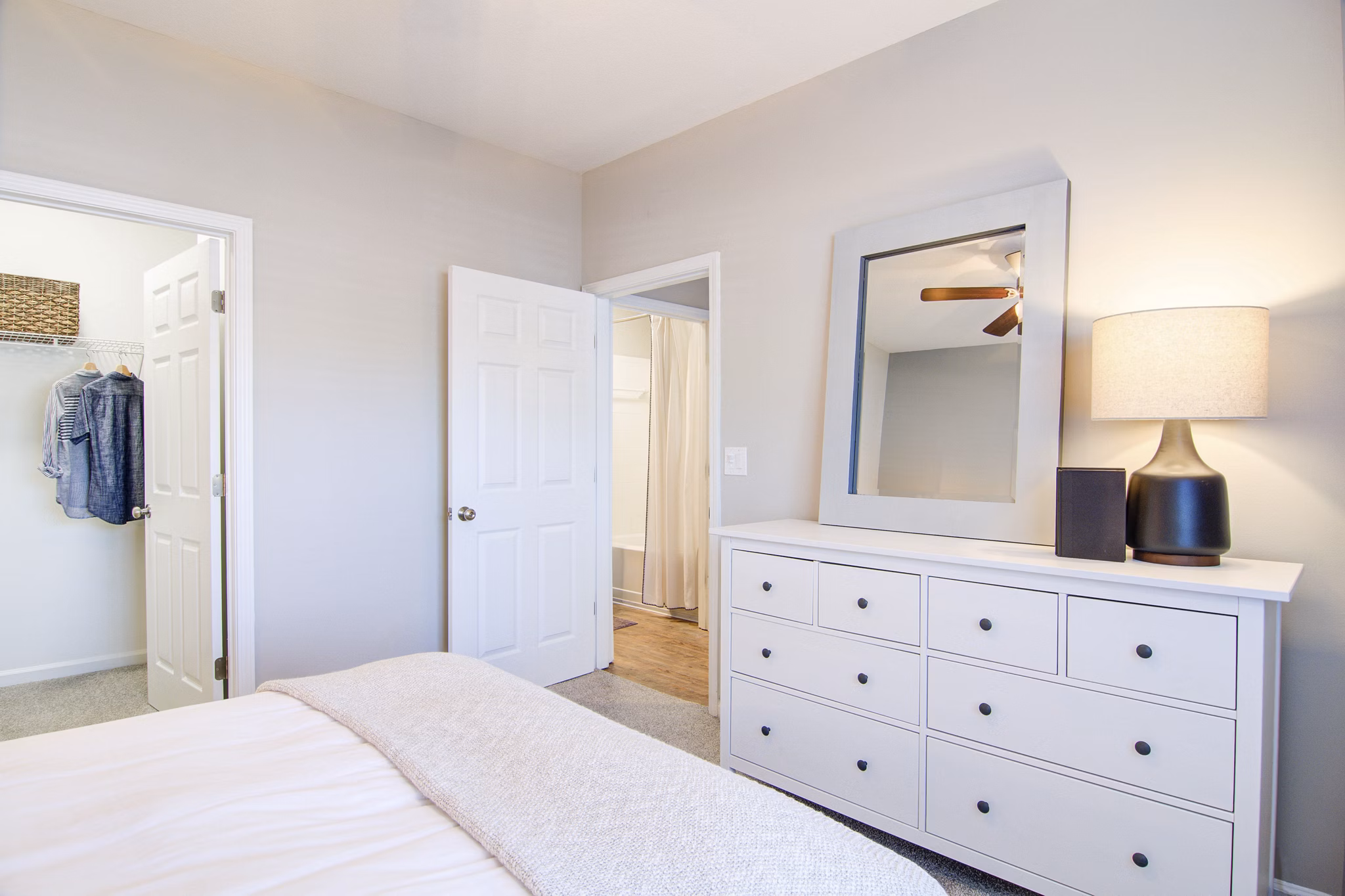 Cozy bedroom with modern decor at Avana North Point Apartments featuring natural light and stylish design