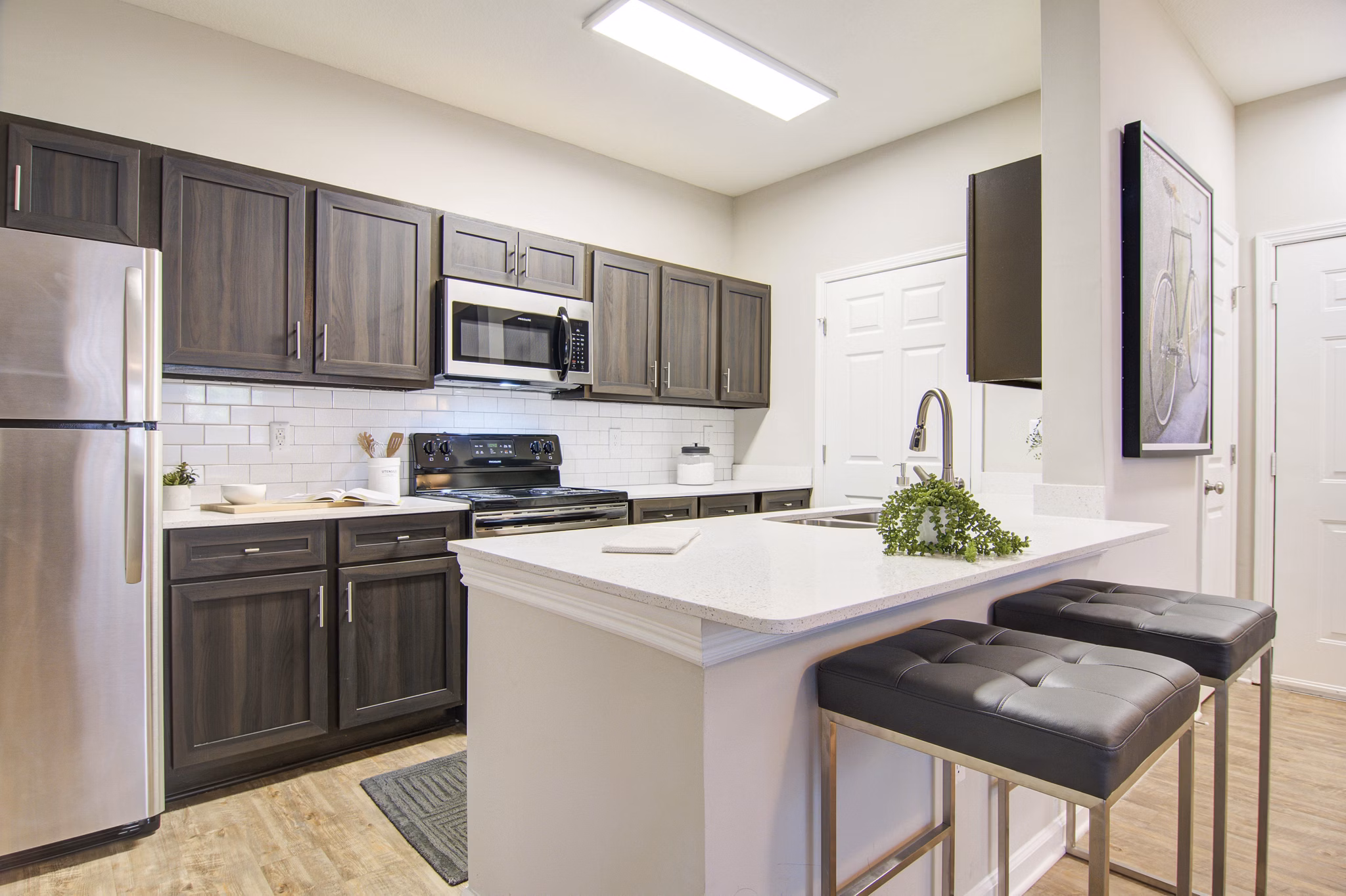 Luxurious kitchen with modern appliances and marble countertops at Avana North Point Apartments