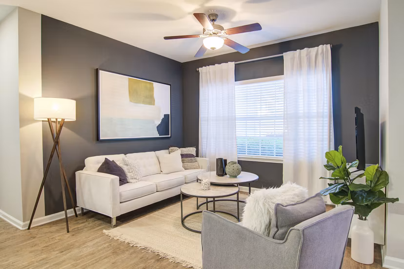 Modern living room with elegant decor at Avana North Point Apartments, featuring plush furnishings and natural light