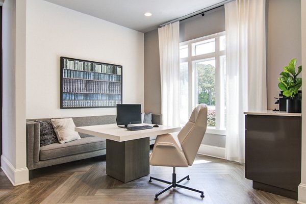 Spacious living room with plush seating and modern decor in Avana North Point Apartments