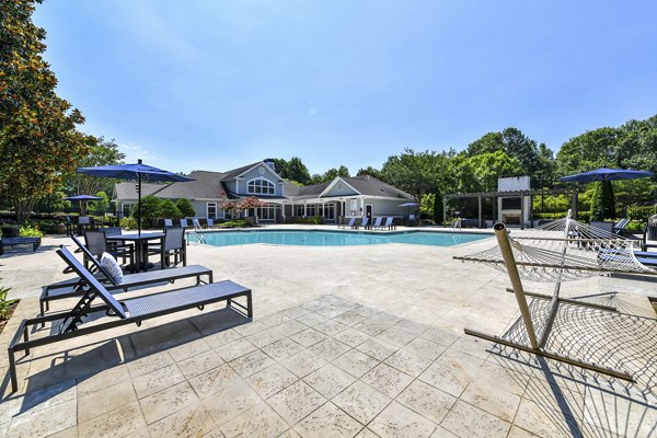 Inviting pool with lounge chairs at Avana North Point Apartments, offering a relaxing retreat at luxury Greystar residences