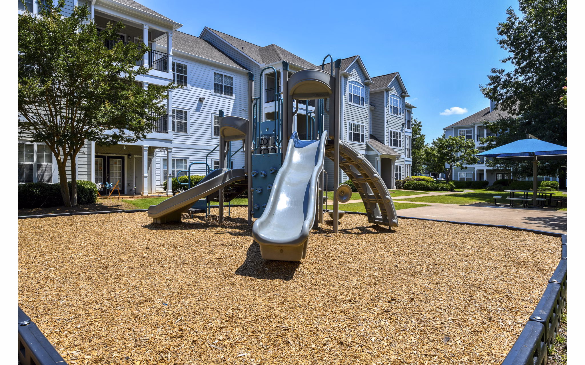 Modern playground with vibrant play structures at Avana North Point Apartments for resident enjoyment