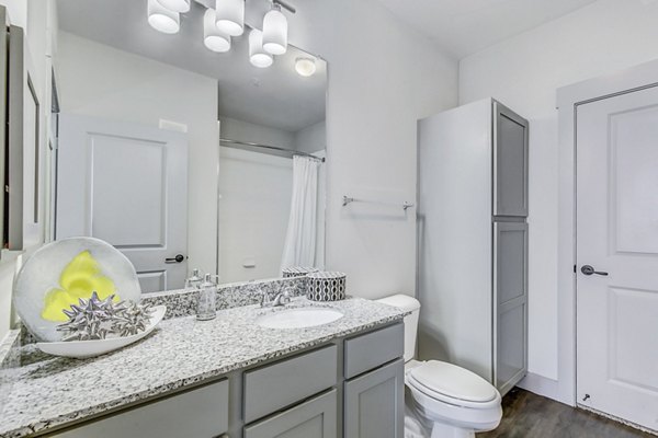 Modern bathroom with sleek fixtures and marble countertops at Landmark on Lovers Apartments