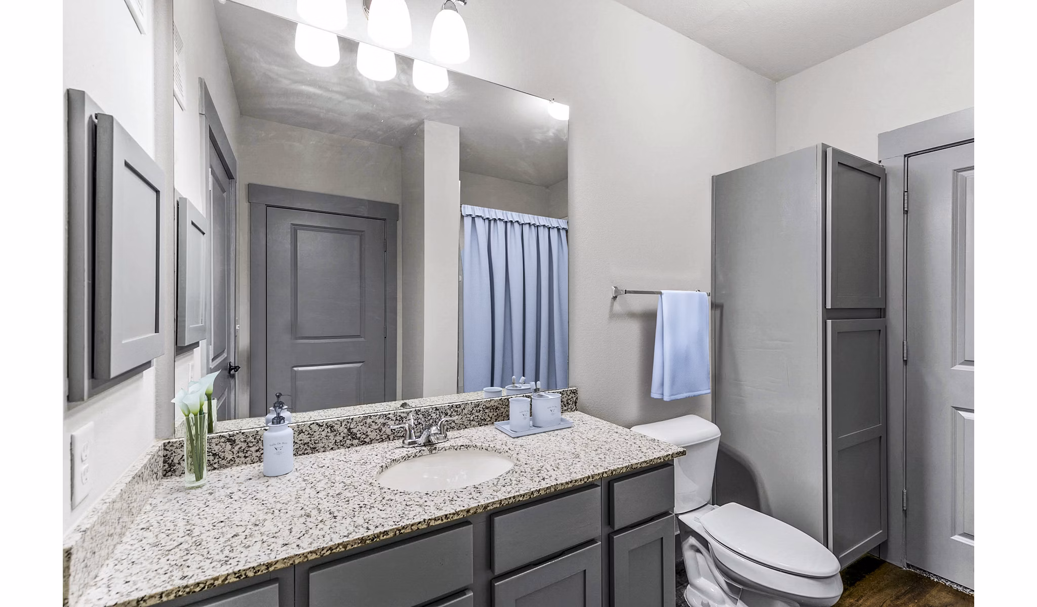 Modern bathroom with double sinks and marble countertops at Landmark on Lovers Apartments