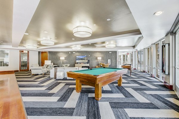 Game room featuring pool table and lounge seating at Landmark on Lovers Apartments
