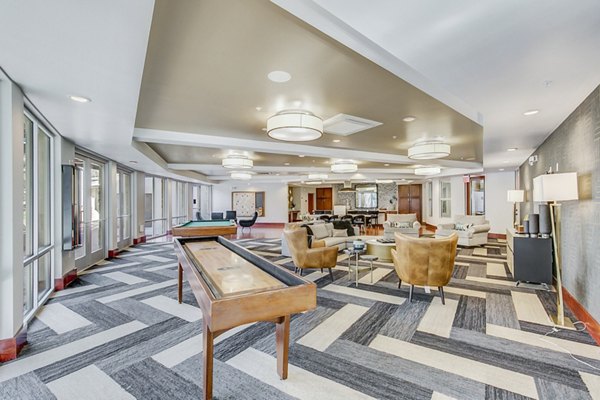 Vibrant game room with pool table and seating at Landmark on Lovers Apartments