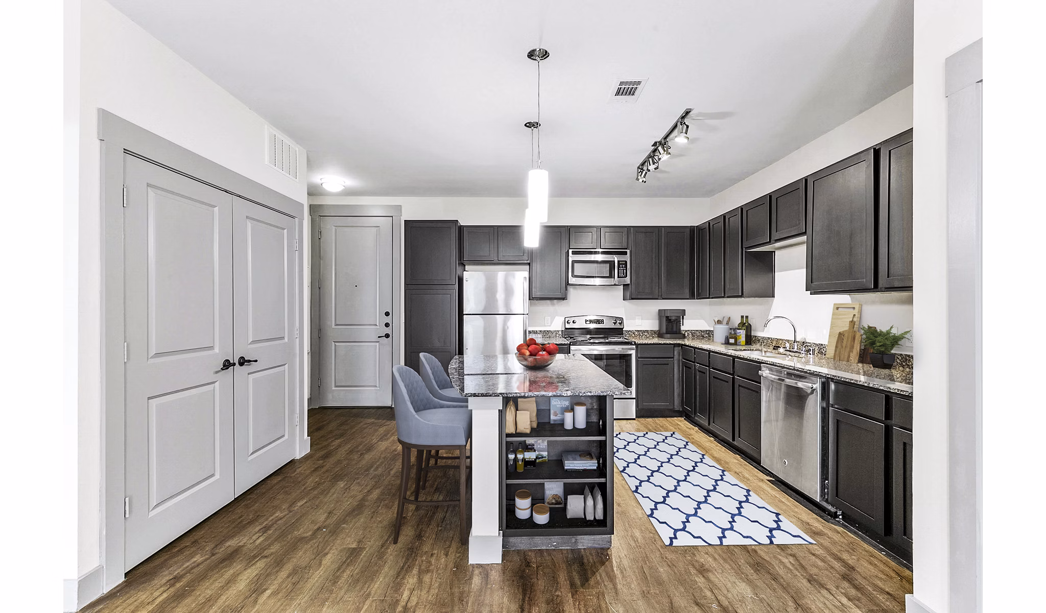 Modern kitchen featuring stainless steel appliances and granite countertops at Landmark on Lovers Apartments