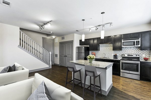 Modern kitchen with sleek countertops and stainless steel appliances at Landmark on Lovers Apartments