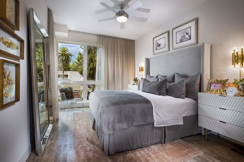 The Hudson Apartments: Cozy bedroom with modern furnishings and ample natural light in luxury apartments