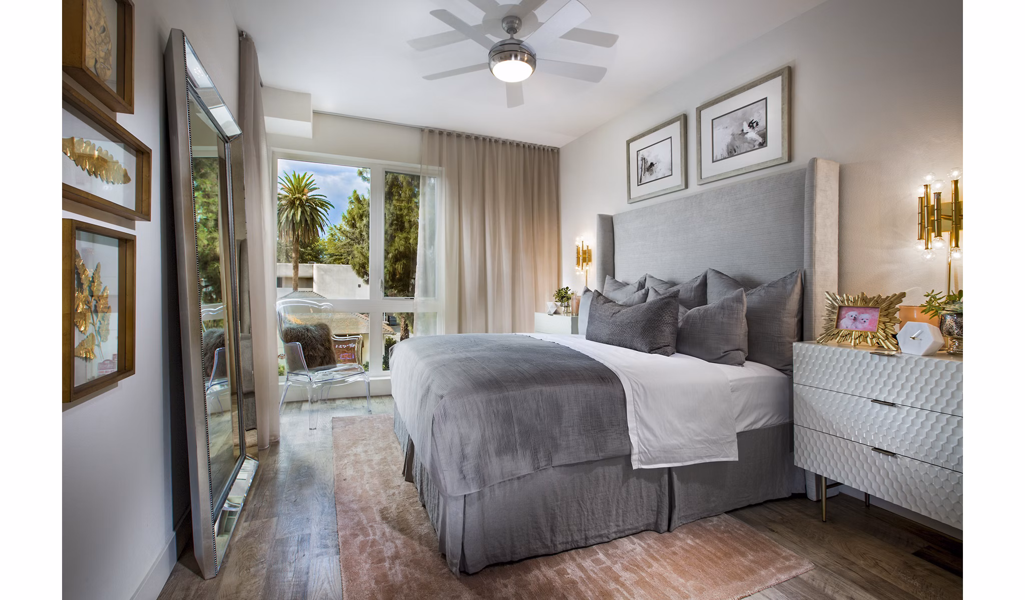 The Hudson Apartments: Cozy bedroom with modern furnishings and ample natural light in luxury apartments