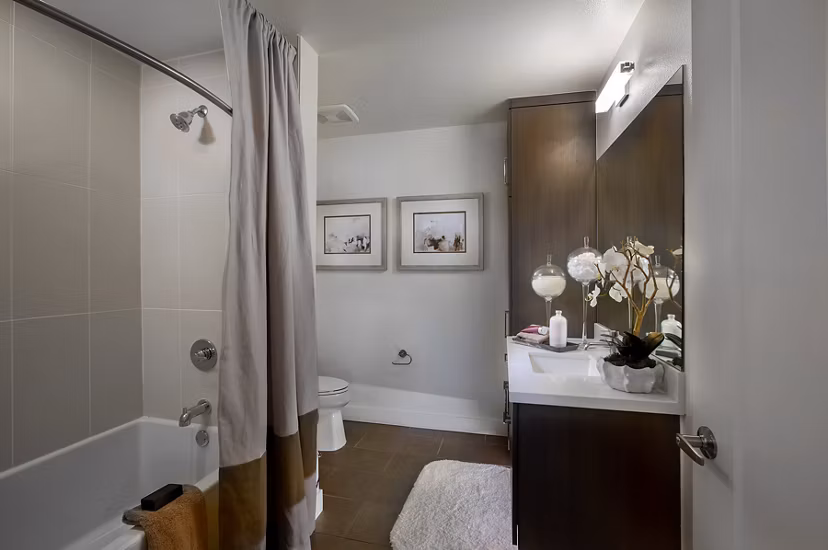 Modern bathroom featuring sleek fixtures and elegant tiling at The Hudson Apartments