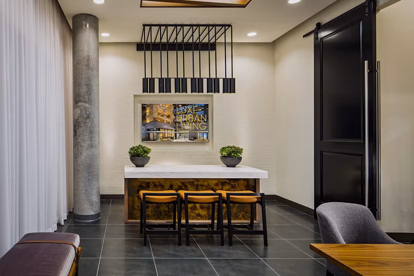 Clubhouse with modern amenities at The Hudson Apartments Spacious space designed for community events and relaxation