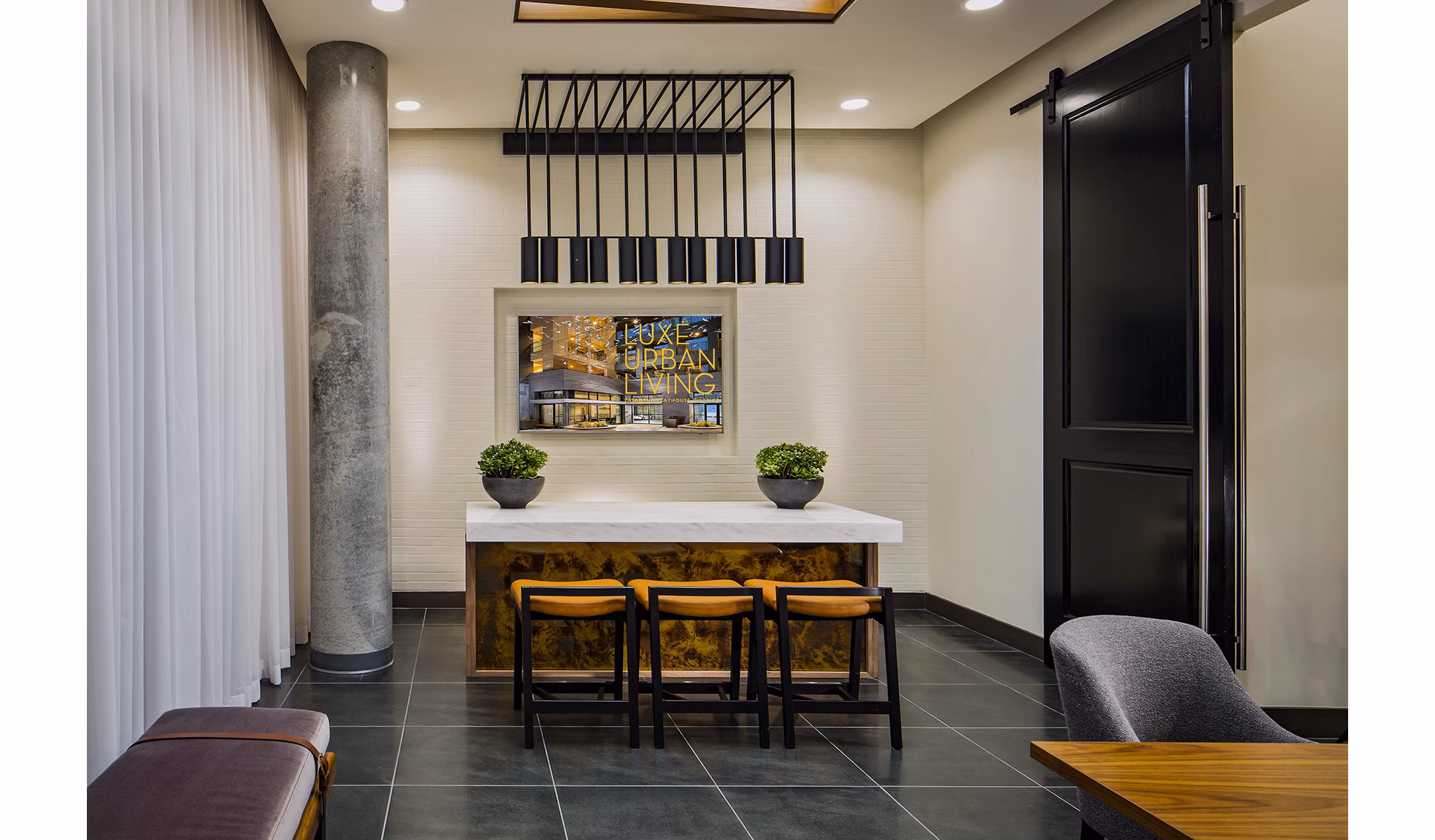 Clubhouse with modern amenities at The Hudson Apartments Spacious space designed for community events and relaxation