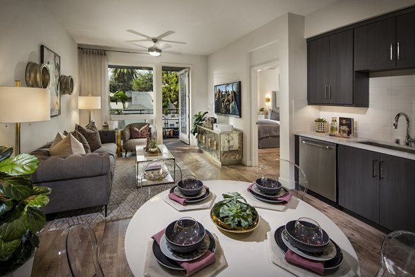 The Hudson Apartments: Elegant dining room with modern furnishings and stylish lighting in luxury Greystar community
