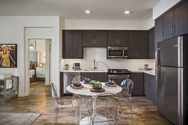 Modern kitchen featuring stainless steel appliances and quartz countertops at The Hudson Apartments luxury living