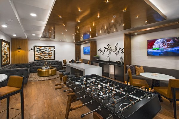 Game room with pool table and arcade games at The Hudson Apartments