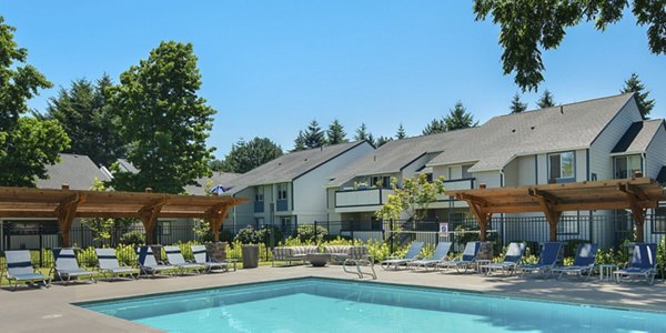 Luxurious pool area with sun loungers at Brookside 112 Apartments, perfect for relaxation and social gatherings in a modern setting