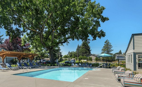 Resort-style pool area with lounging chairs at Brookside 112 Apartments, offering a perfect outdoor relaxation spot for residents