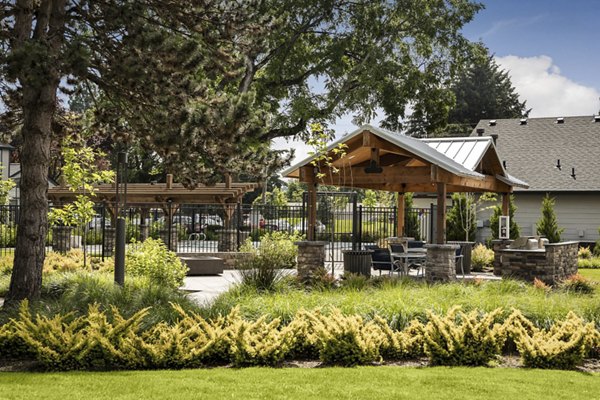 Outdoor grill area with modern seating at Brookside 112 Apartments, ideal for entertaining and relaxation